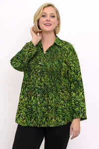 Close-up of model wearing long sleeve green leaf print shirt with smocked bodice