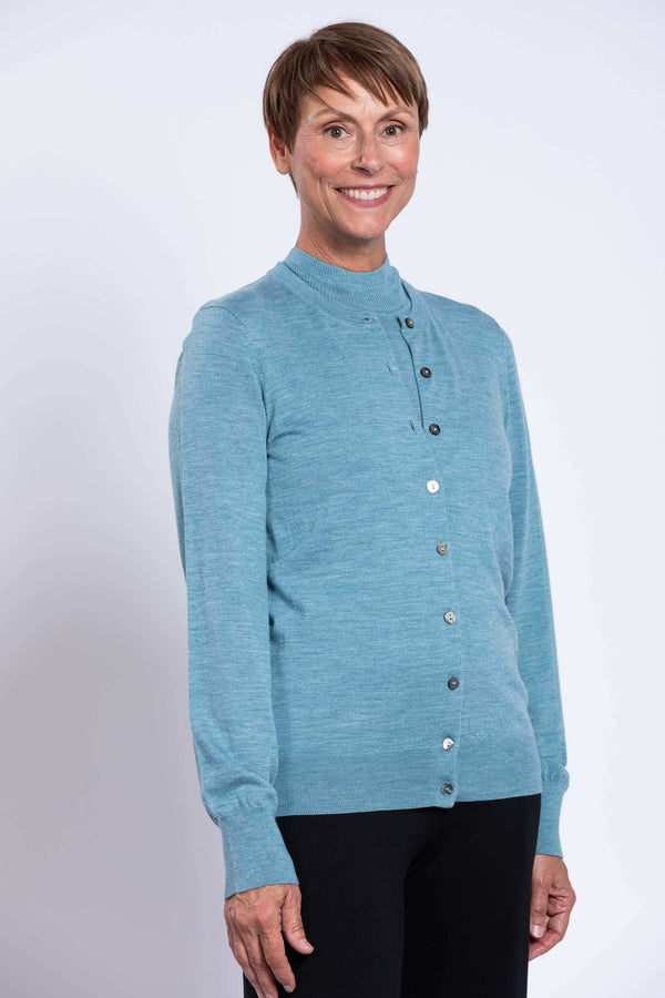 Close-up of older woman in blue Kitten Cardigan with button and crew neck detail