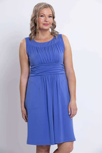 Woman in blue dress showing ruched bodice and waistband, close-up front view