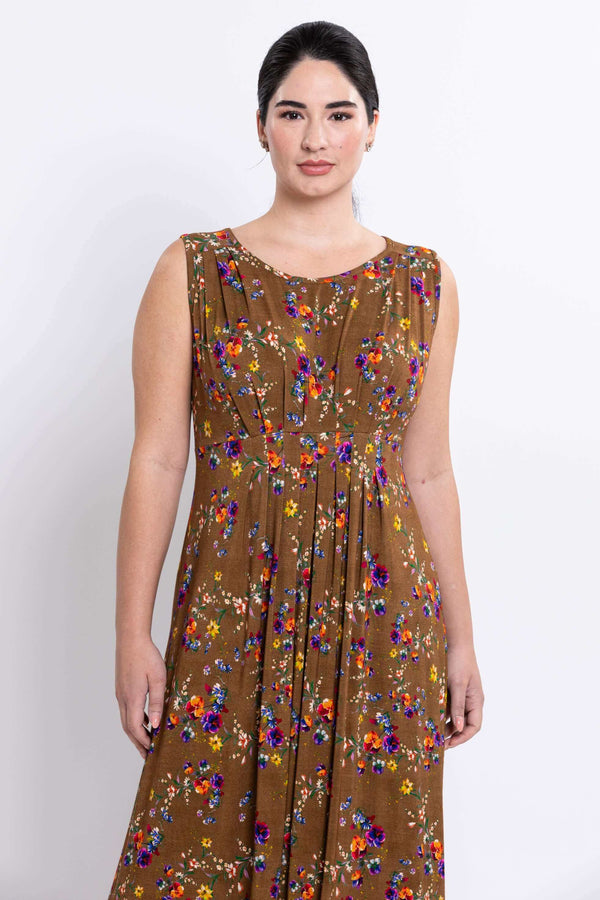 Close-up of sleeveless brown floral maxi dress showing pleat details