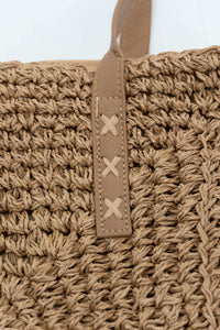 Close-up of paper tote bag's woven texture and stitched tan handle