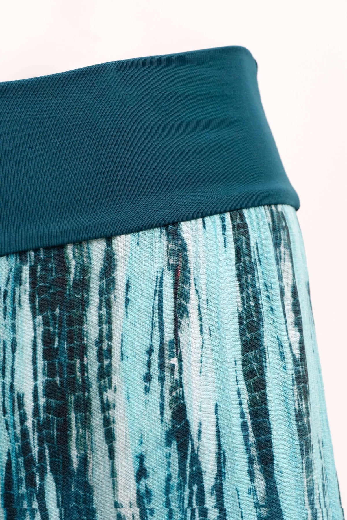 Close-up of the wide knit waistband and blue striped fabric on Landon Capri Pants