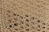 Macro detail of the intricate natural woven texture of the eco-friendly backpack