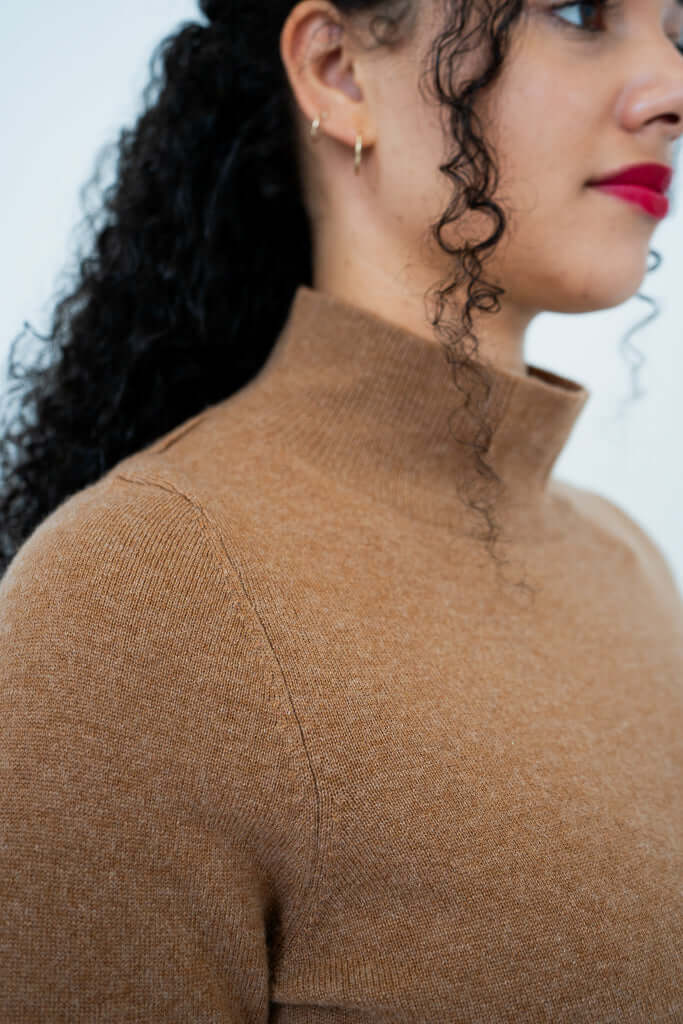 Close-up side view of camel mock neck sweater collar and shoulder