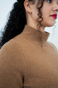 Close-up side view of camel mock neck sweater collar and shoulder