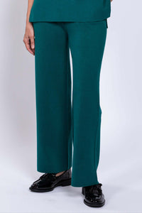 Close-up view of teal wide-leg pants with smooth waistband