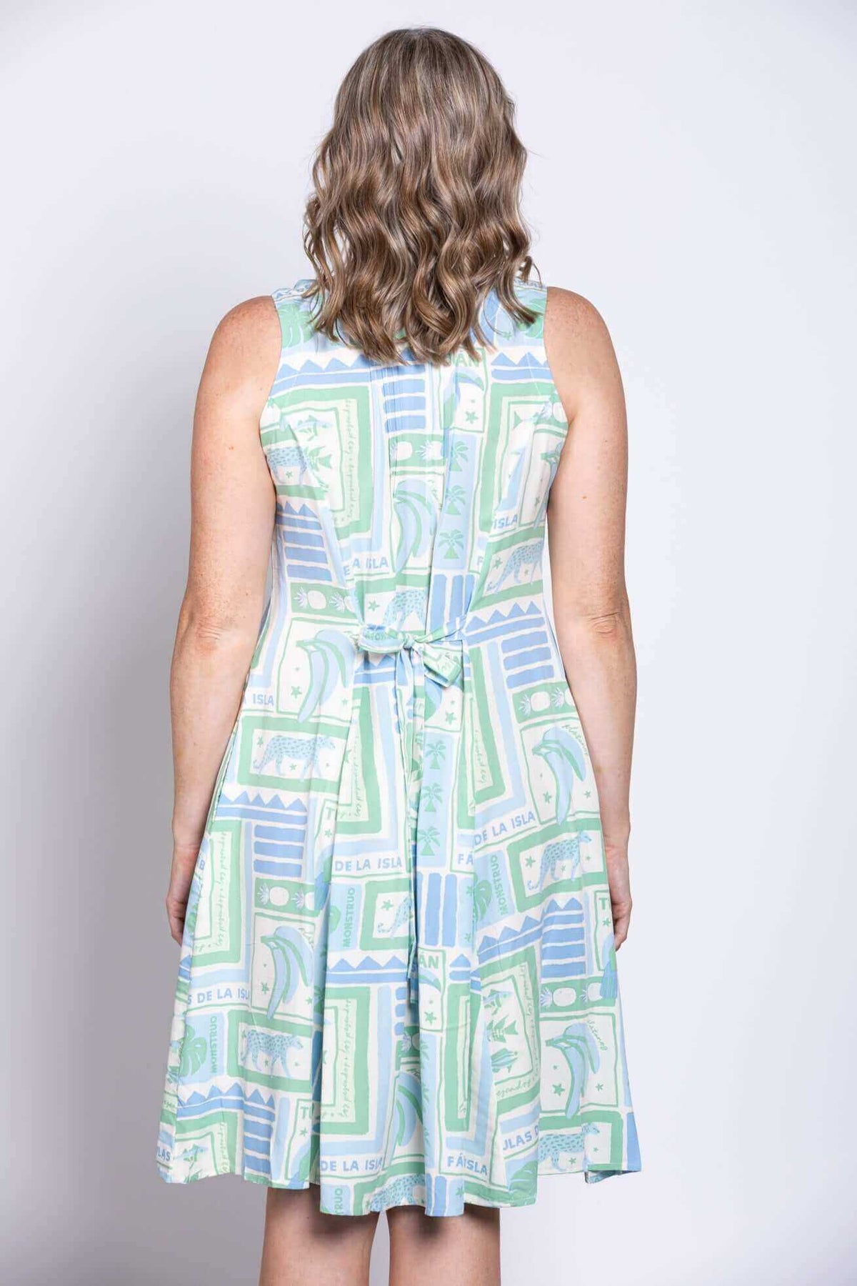 Detail of the tie-back feature on the rear of the light geometric print dress