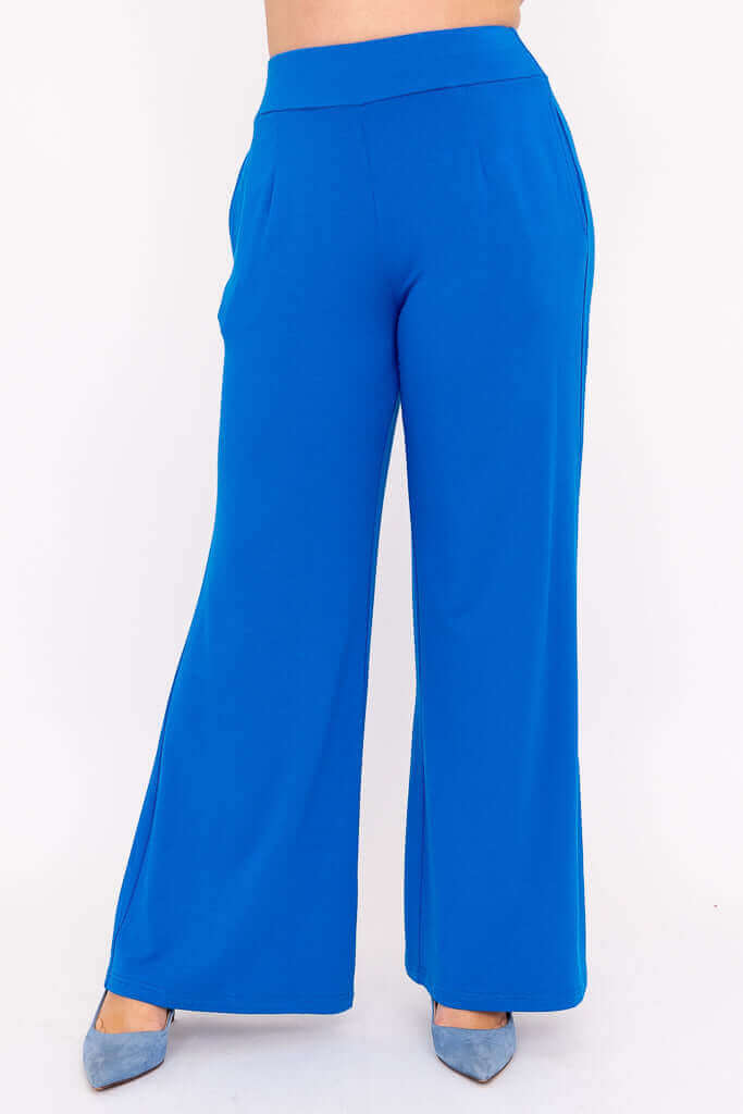 Cobalt blue Jondo wide leg pants shown from the front with hands in pockets