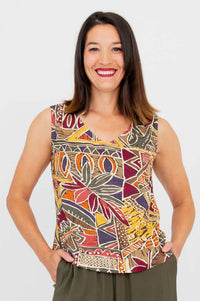 Woman wearing a sleeveless tank with a colorful geometric pattern, smiling