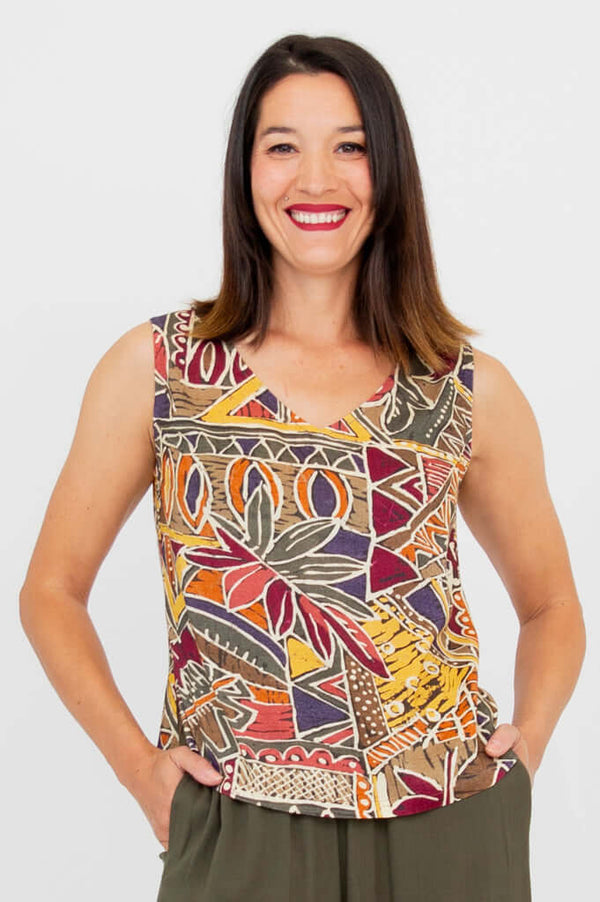 Woman wearing a sleeveless tank with a colorful geometric pattern, smiling