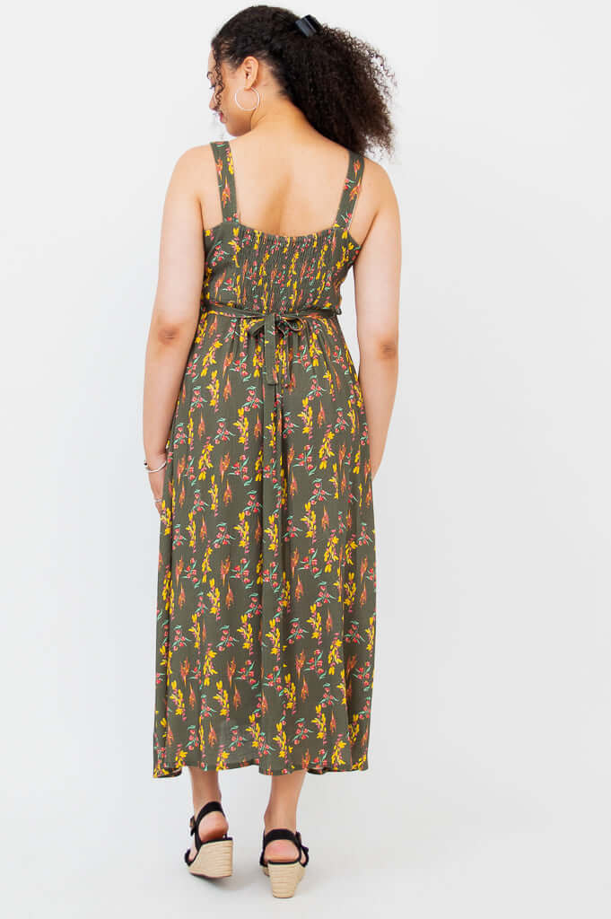 Back view showing shirred bodice and tie belt of the Coraline floral maxi dress