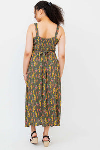 Back view showing shirred bodice and tie belt of the Coraline floral maxi dress