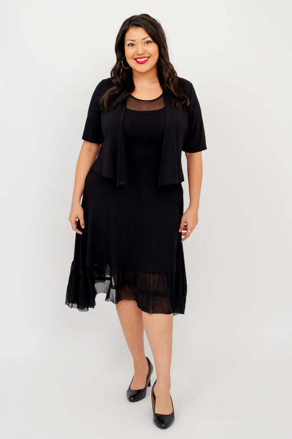 Model in black mesh hem dress paired with short sleeve black jacket