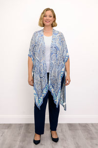 Front view of woman wearing blue paisley patterned kimono on white top outfit against a white background 