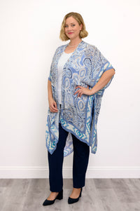 Front view of woman wearing blue paisley patterned kimono on white top outfit against a white background 