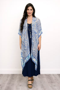 Front view of woman wearing blue paisley patterned kimono on a blue outfit against a white background 