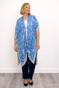 Front view of woman wearing blue lace patterned kimono on white and blue outfit against a white background 