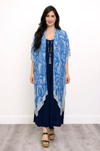 Front view of woman wearing blue lace patterned kimono on navy blue outfit against a white background 