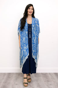 Front view of woman wearing blue lace patterned kimono on navy blue outfit against a white background 