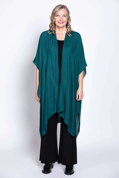 Front view of a woman wearing a teal Darcy kimono wrap over black outfit