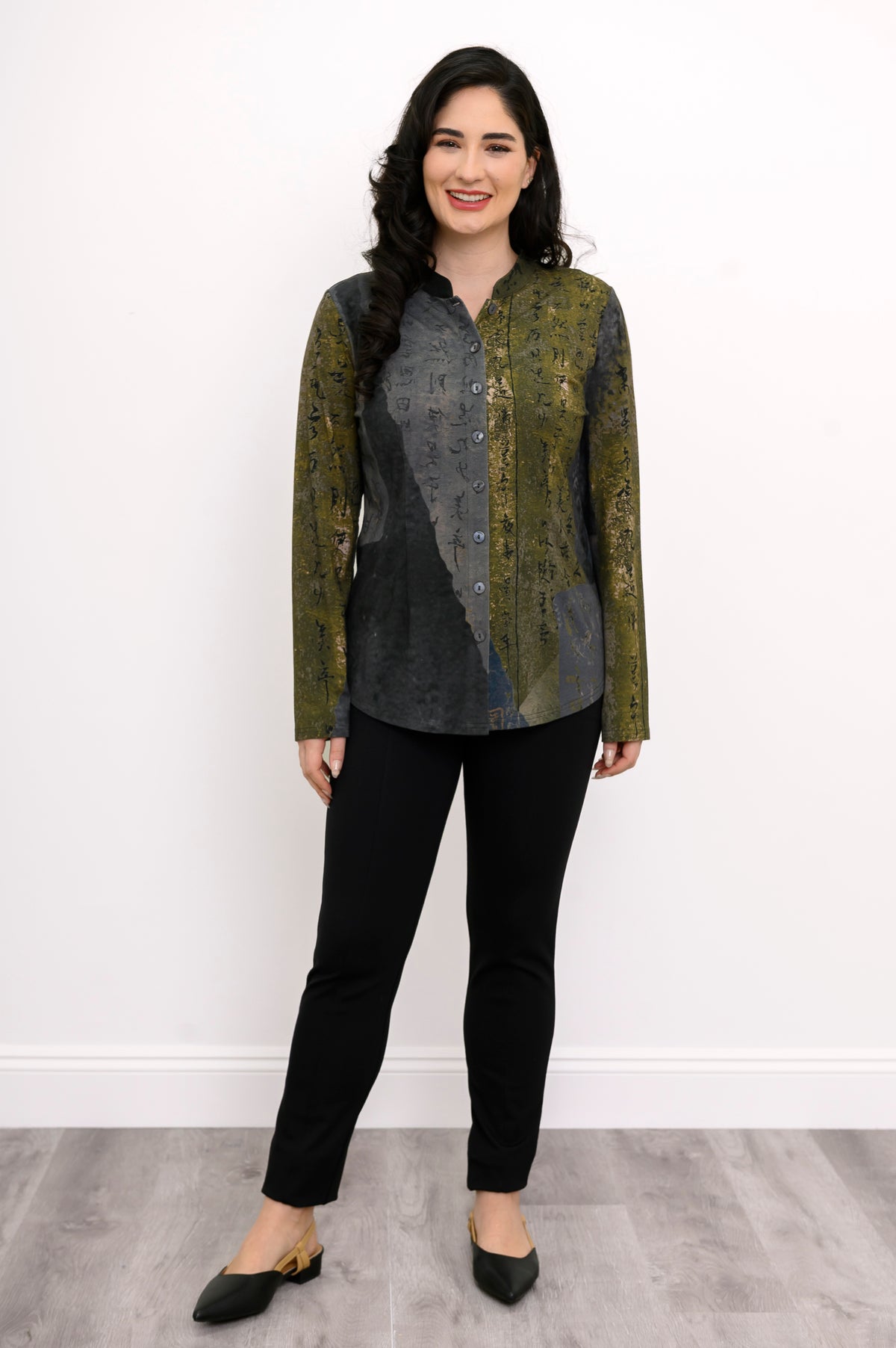 Model in a soft bamboo-cotton long-sleeve top with an earthy print and a subtle split mandarin neckline.