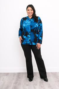 Full front view of a tailored blue floral blouse showing the polished button closure and slim cuffed sleeves.