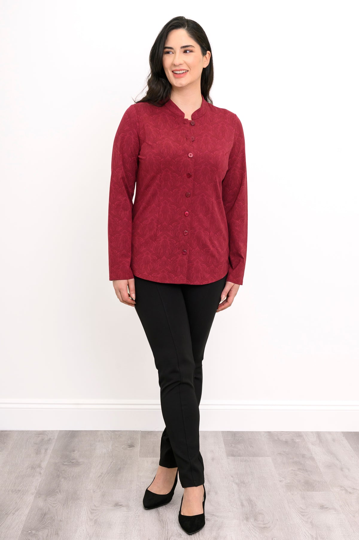 Women's long-sleeve patterned red pullover tunic with button closures and a mandarin collar, front pose.