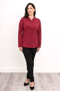 Women's long-sleeve patterned red pullover tunic with button closures and a mandarin collar, front pose.