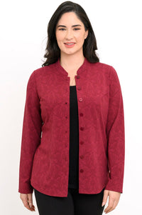 Smiling woman wearing a red patterned button-up knit shirt open over a black top, shown in a front view.