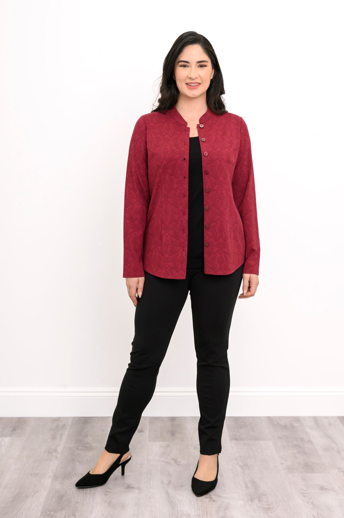 Front view of a relaxed-fit crimson patterned knit cardigan showing a button-down placket and long sleeves.