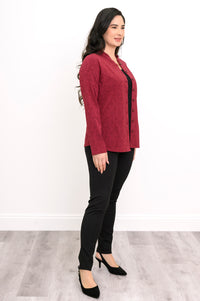 Profile shot of a crimson geometric print bamboo knit jacket showing a straight hip-length hem and casual drape.
