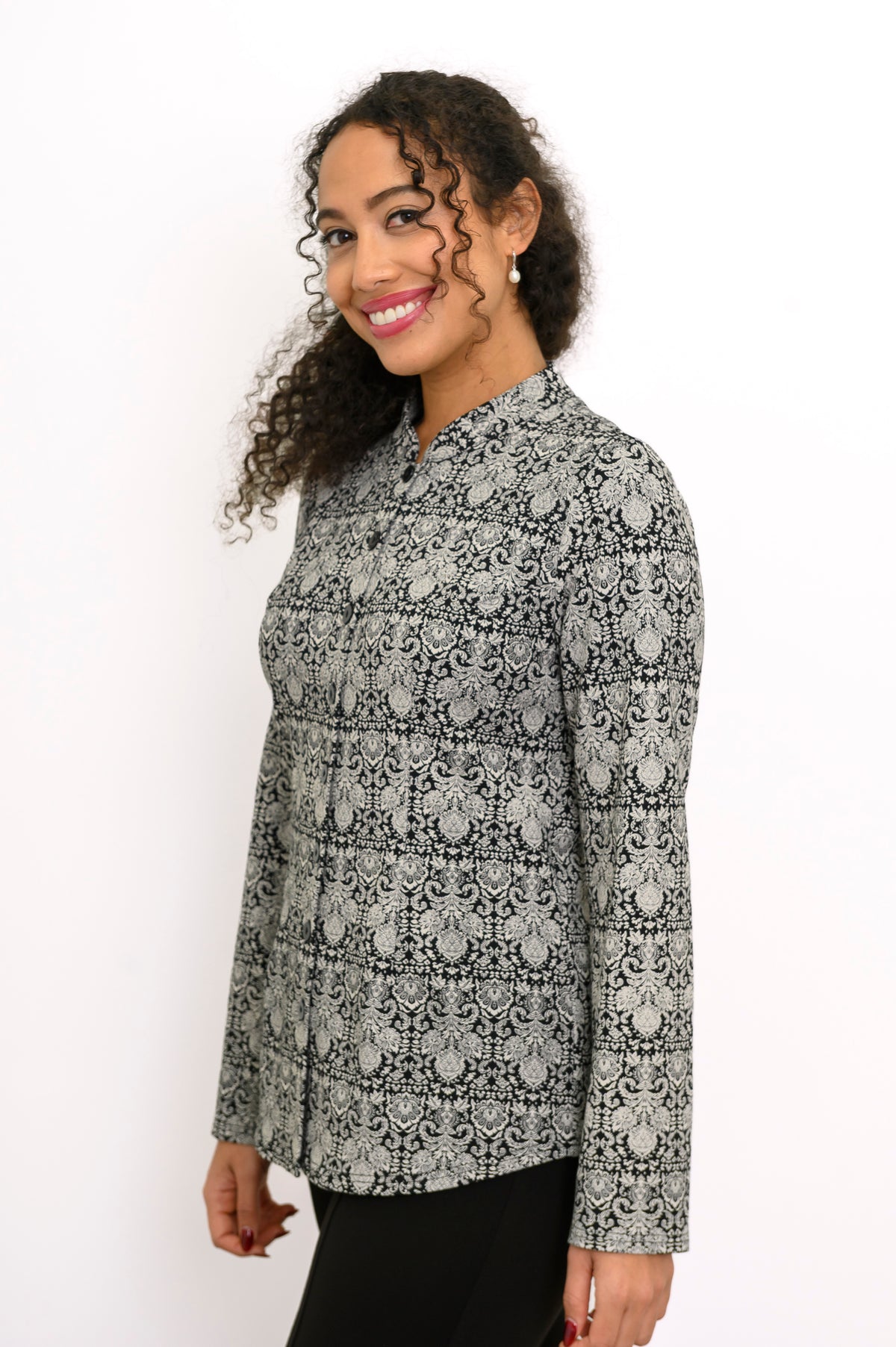 Side view of a patterned grey bamboo blouse highlighting the tailored fit, cuffed sleeve, and straight hemline