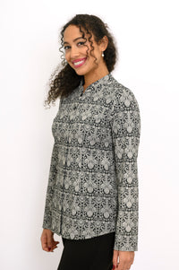 Side view of a patterned grey bamboo blouse highlighting the tailored fit, cuffed sleeve, and straight hemline