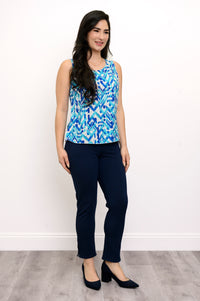 Front view of woman wearing a blue patterned sleeveless top and navy pants against a white background