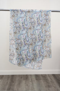 A large silk scarf with a blue, pink, and green paisley pattern displayed on a metal rod against a white background, front view