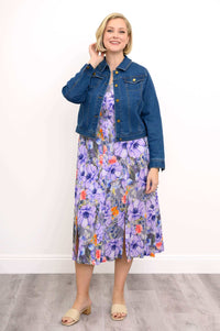 Woman in a denim jacket over a purple floral Morgan dress, front view