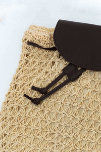 Close-up of brown flap and drawstring detail on natural woven backpack