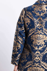 Close-up of the gold baroque pattern on the navy jacquard coat