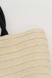Close-up of woven bag material showing metallic silver stripes and detailed texture