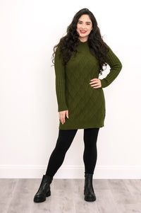 Front view of a woman modeling a breathable 100% cotton vintage green cable knit tunic for winter wear.