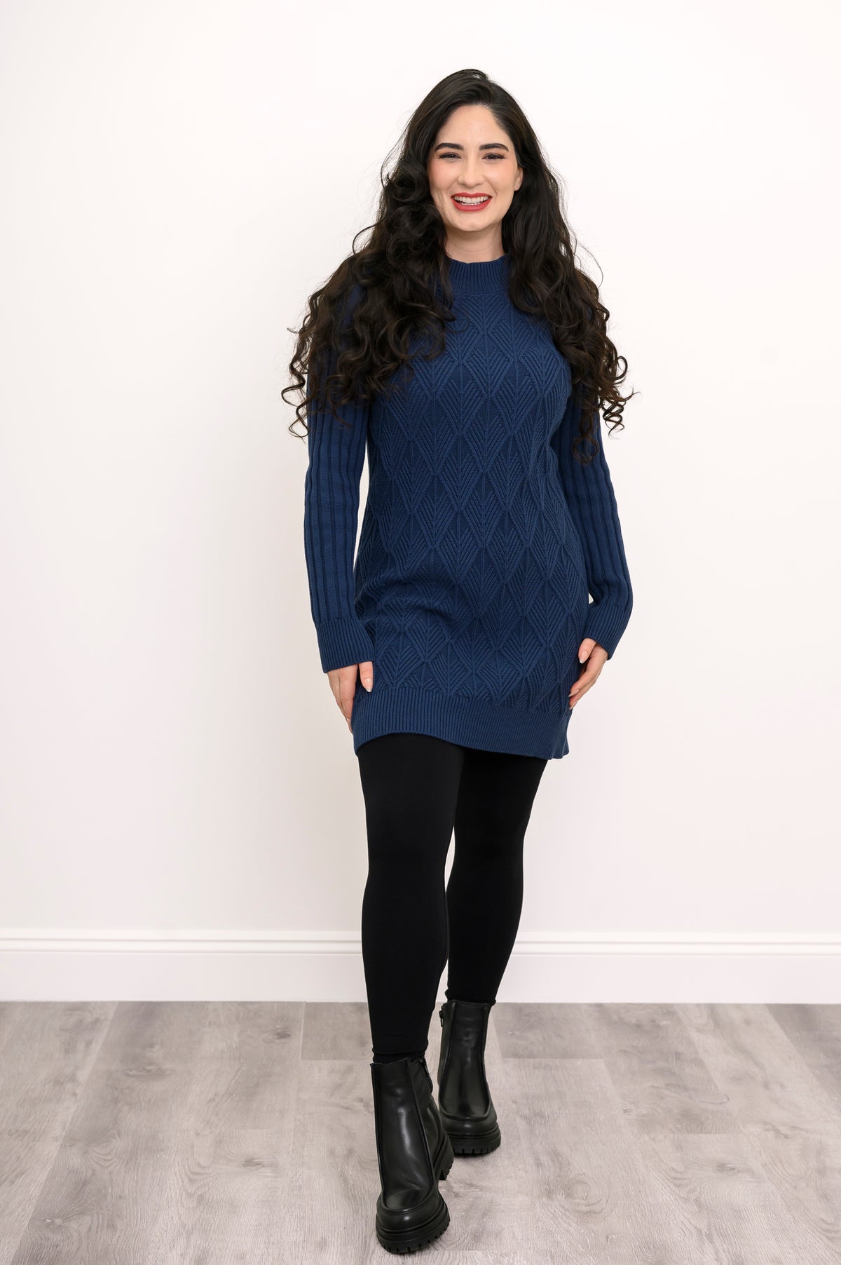 Front view of a woman modeling a breathable 100% cotton vintage indigo cable knit tunic for winter.