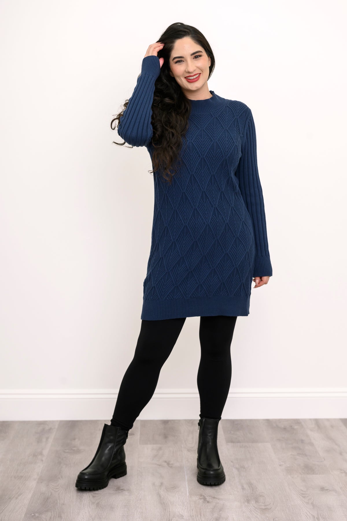 Full body shot of a model wearing a long vintage indigo cable knit pullover sweater tunic with tights.