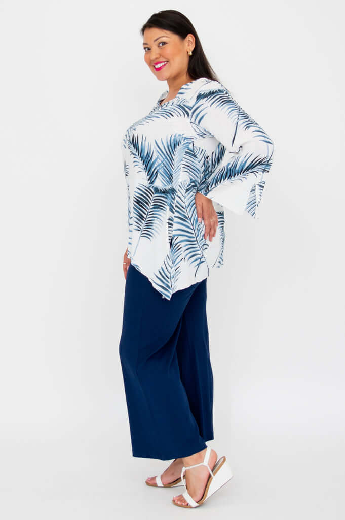 Side profile of model in Dorothy flowy top and wide-leg navy pants