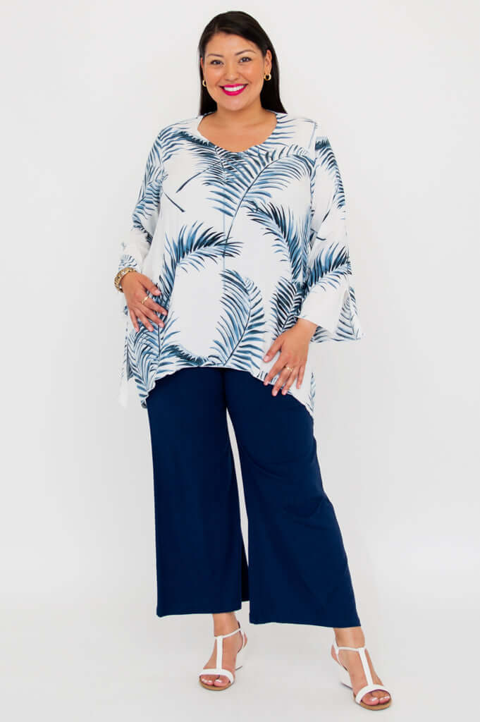 Full front view of model in Dorothy top with blue foliage pattern and flared sleeves