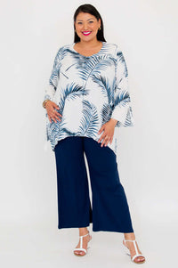 Full front view of model in Dorothy top with blue foliage pattern and flared sleeves