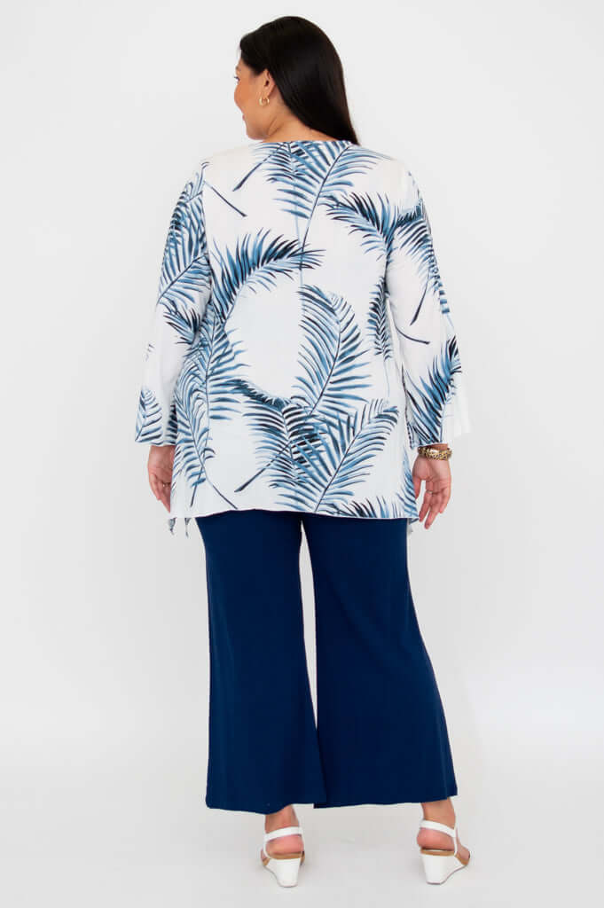 Back view of model wearing Dorothy top with blue palm pattern and wide-leg pants