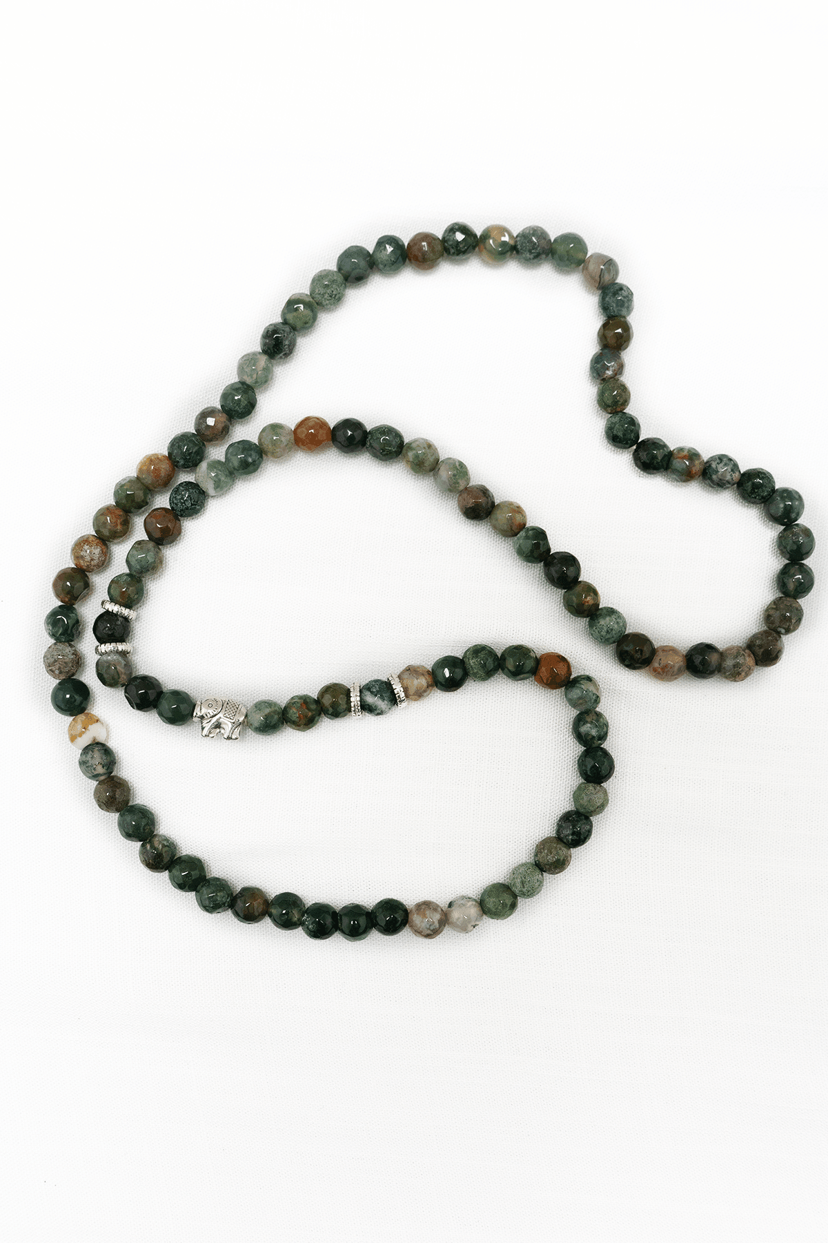 Earthy agate bead mala necklace with silver elephant charm displayed on a white background