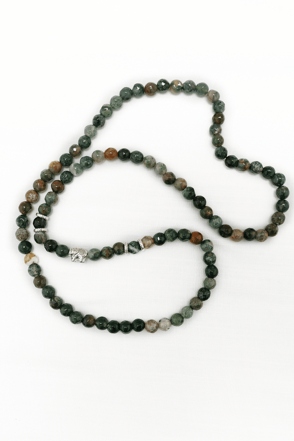 Earthy agate bead mala necklace with silver elephant charm displayed on a white background