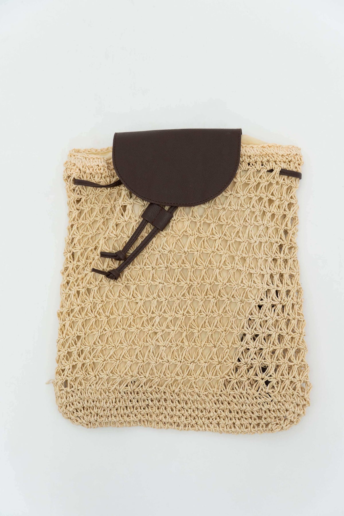 Eco-friendly woven backpack with dark brown flap and drawstring closure on white background