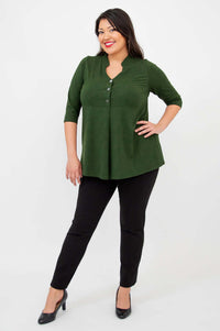 Full body view of a woman in the Edwina dark green bamboo V-neck top and black pants